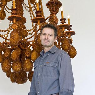 Headshot of Timothy Horn with an artwork sample in the background