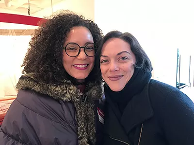 Artist Lydia Marie Hicks with a visitor at the exhibit reception