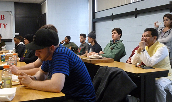 Professor VG listening to a presentation with students