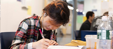 student writing on paper